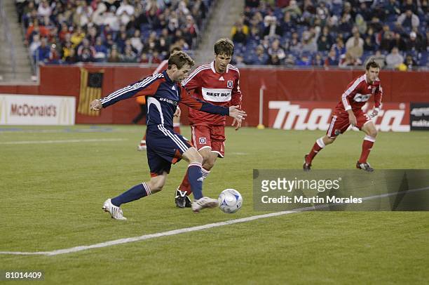 Steve Ralston of the New England Revolution moves past Logan Pause of the Chicago Fire during their game on May 3, 2008 at Gillette Stadium in...