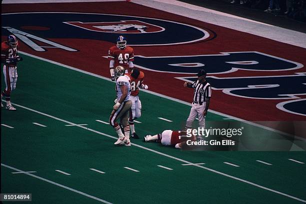 Linebacker Karl Mecklenburg of the Denver Broncos is down with a leg injury against the San Francisco 49ers in Super Bowl XXIV at the Superdome on...