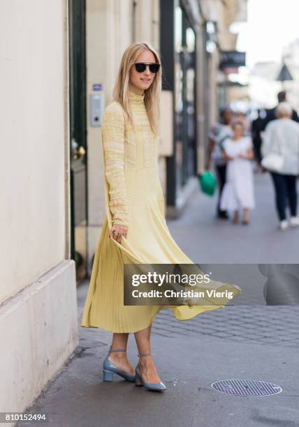 Charlotte Groeneveld wearing a golden dress outside Valentino during Paris Fashion Week - Haute Couture Fall/Winter 2017-2018 : Day Four on July 5,...