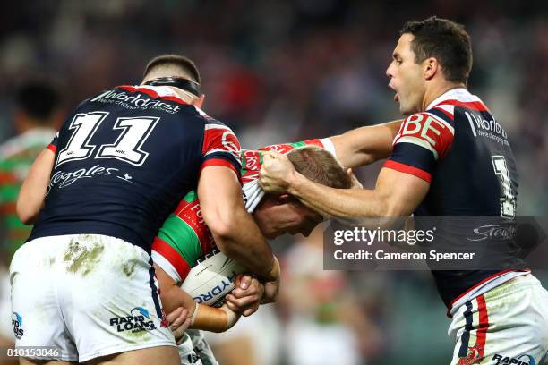 Jason Clark of the Rabbitohs is tackled during the round 18 NRL match between the Sydney Roosters and the South Sydney Rabbitohs at Allianz Stadium...