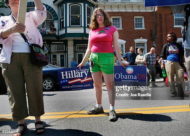 People hold signs in support of Democratic presidential hopefuls U.S. Senator Hillary Clinton and Senator Barack Obama during her campaign event at...