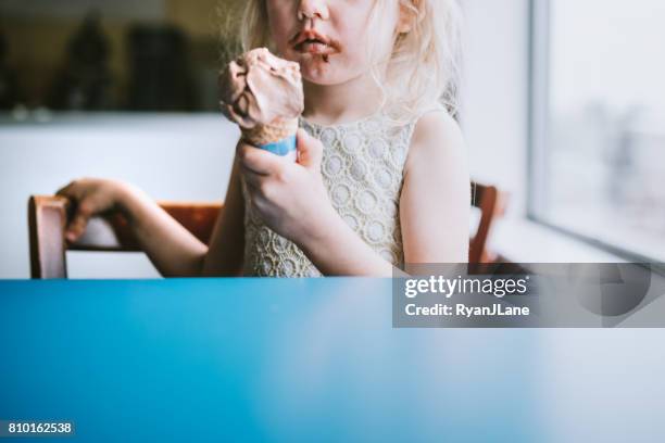 girl eating ice cream cone - girl eating messy ice cream cone stock pictures, royalty-free photos & images