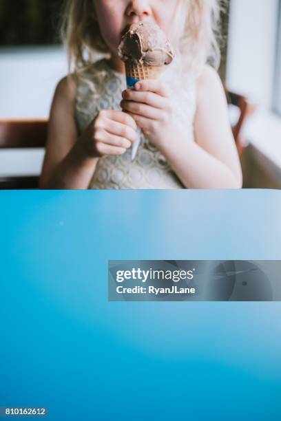girl eating ice cream cone - girl eating messy ice cream cone stock pictures, royalty-free photos & images