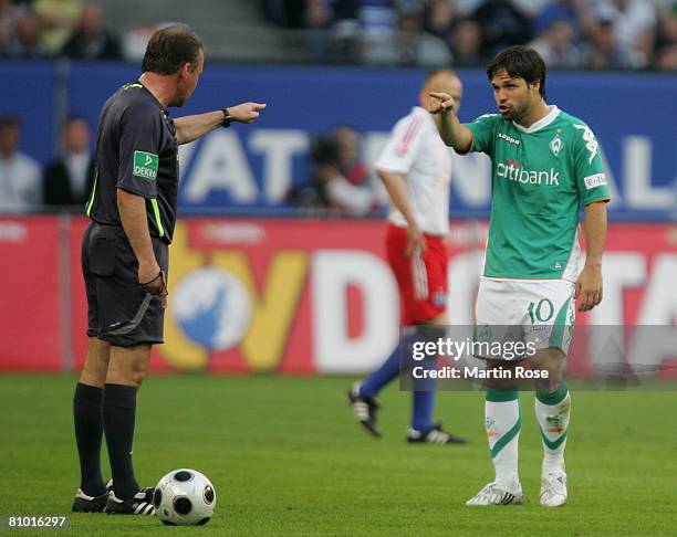 Diego of Bremen argues with referee Lutz Wagner during the Bundesliga match between Hamburger SV and Werder Bremen at the HSH Nordbank Arena on May...