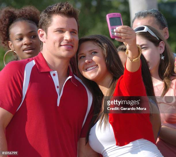 Singer and actor Nick Lachey poses for a picture with an audition paticipant during the Disney's High School Musical Get in the Picture Session...