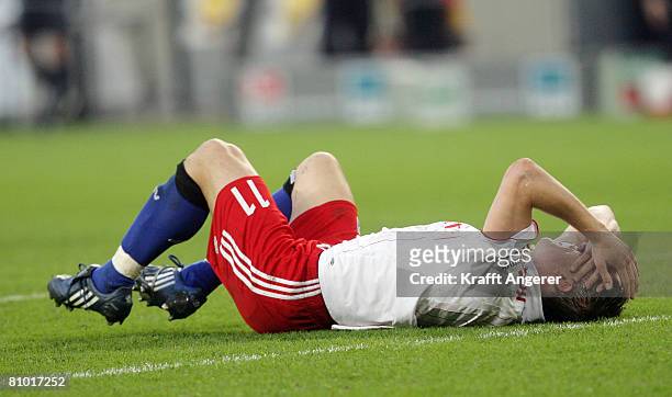 Ivica Olic of Hamburg is injured during the Bundesliga match between Hamburger SV and Werder Bremen at the HSH Nordbank Arena on May 7, 2008 in...