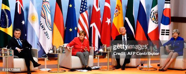 Argentinia's President Mauricio Macri, German Chancellor Angela Merkel, US President Donald Trump and Britain's Prime Minister Theresa May sit at the...