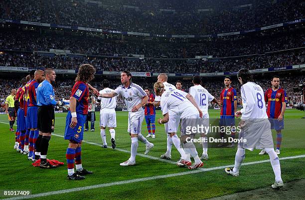 Barcelona players form a guard of honour for La Liga champions Real Madrid before the start of the La Liga match between Real Madrid and Barcelona at...