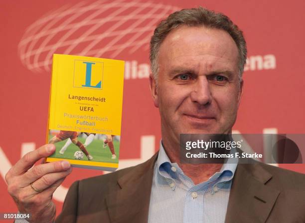 Karl-Heinz Rummenigge, chairman of executive board of FC BAyern Munich AG, presents the Langenscheidt UEFA dictionary at a press conference prior to...