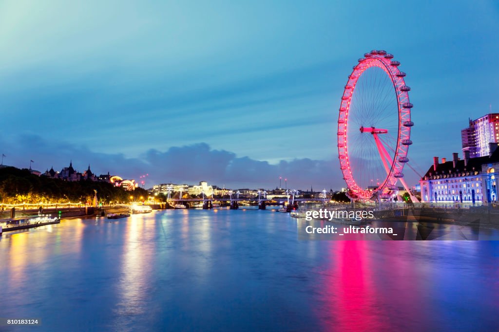 View of red London Eye and Hungerford Bridge at dusk