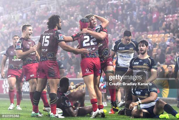 Hamish Stewart of the Reds is congratulated by team mates after scoring a try during the round 16 Super Rugby match between the Reds and the Brumbies...
