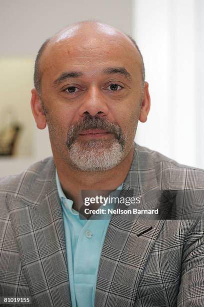 Shoe designer Christian Louboutin poses for a photograph at the launch of his new fall collection at Barneys New York on May 7, 2008 in Beverly...