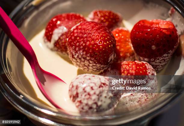 Tennis fan eats strawberries and cream on day five of the Wimbledon Lawn Tennis Championships at the All England Lawn Tennis and Croquet Club on July...