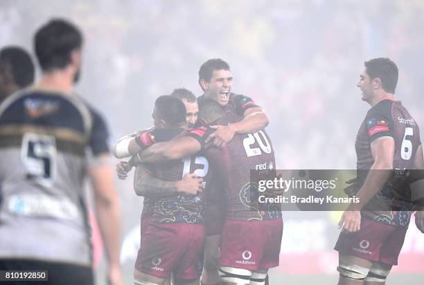 Quade Cooper of the Reds and team mates celebrate victory after the round 16 Super Rugby match between the Reds and the Brumbies at Suncorp Stadium...