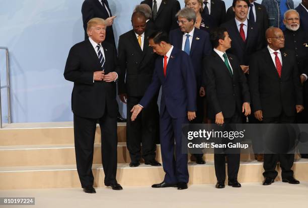 President Donald Trump , Indonesian President Joko Widodo and other leaders attend the group photo on the first day of the G20 economic summit on...