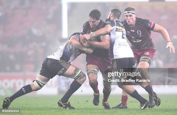 Rob Simmons of the Reds takes on the defence during the round 16 Super Rugby match between the Reds and the Brumbies at Suncorp Stadium on July 7,...