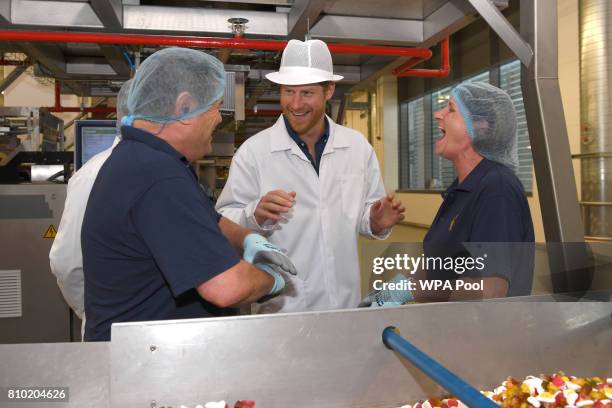 Britain's Prince Harry chats with employees during his visit to the Haribo sweet factory during an official visit to Leeds on July 7, 2017 in Leeds,...