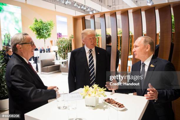In this photo provided by the German Government Press Office , Donald Trump, President of the USA meets Vladimir Putin, President of Russia and...