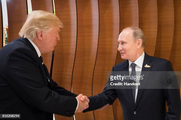 In this photo provided by the German Government Press Office Donald Trump, President of the USA , meets Vladimir Putin, President of Russia , at the...