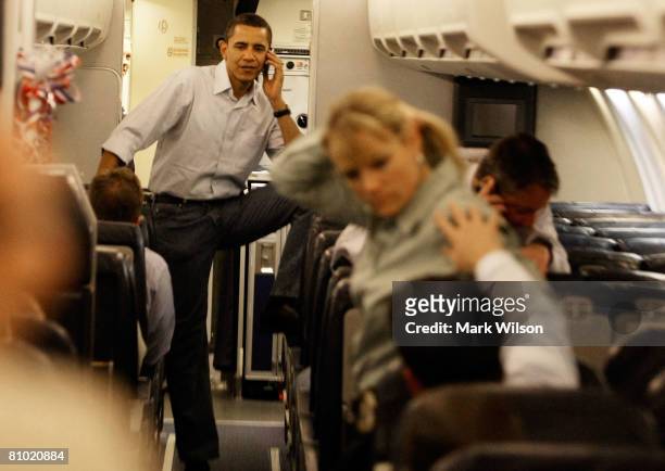 Democratic presidential hopeful Sen. Barack Obama talks on his cell phone after boarding his campaign plane at Midway Airport en-route to Washington...