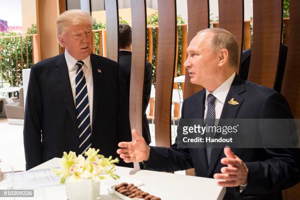In this photo provided by the German Government Press Office , Donald Trump, President of the USA meets Vladimir Putin, President of Russia during...