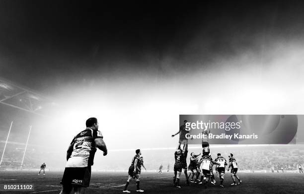 Players compete at the lineout as fog can be seen blanketing the ground during the round 16 Super Rugby match between the Reds and the Brumbies at...