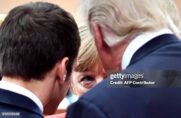 French President Emmanuel Macron, German Chancellor Angela Merkel and US President Donald Trump confer at the start of the first working session of...