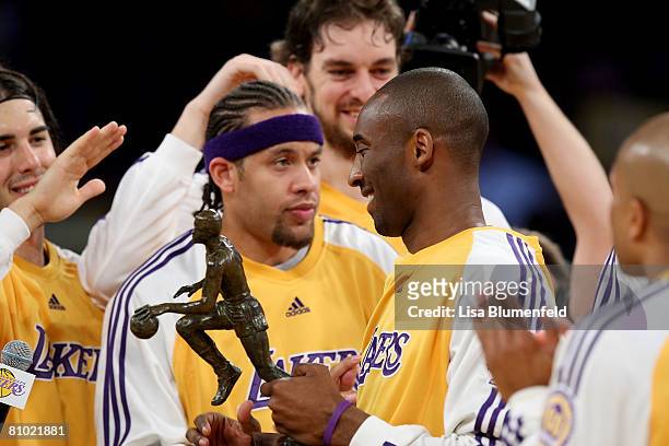 Kobe Bryant of the Los Angeles Lakers is congratulated by his teammates after accepting the 2008 MVP Trophy before the game against the Utah Jazz in...