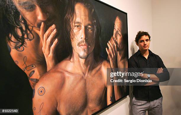 Artist Vincent Fantauzzo poses beside his winning entry a portrait of the late actor Heather Ledger titled 'Heath' awarded as the winner of the...