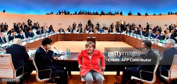 German Chancellor Angela Merkel turns around as US President Donald Trump, China's President Xi Jinping, Argentinia's President Mauricio Macri and...