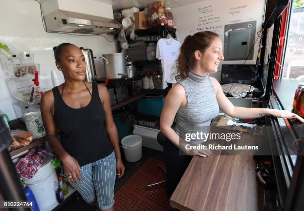 It's a tight space as volunteers Camille Williams and Stephanie Bishop help prepare and serve food.. For weekly new-business profile, Jagger Gordon...