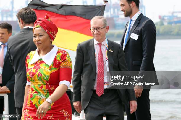 Wife of South Africa's President Thobeka Madiba-Zuma and the husband of Britain's Prime Minister Philip John May leave a ship after a boat tour of...