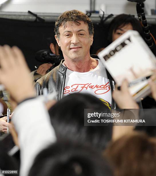 Actor Sylvester Stallone greets fans upon his arrival for the premiere of his latest movie, "Rambo" in Tokyo on May 8, 2008. "Rambo" will roadshow in...