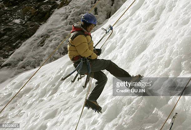 Member of a class for mountain guides practises at a training base at Siguniang mountain in China's southwestern province of Sichuan on February 26,...