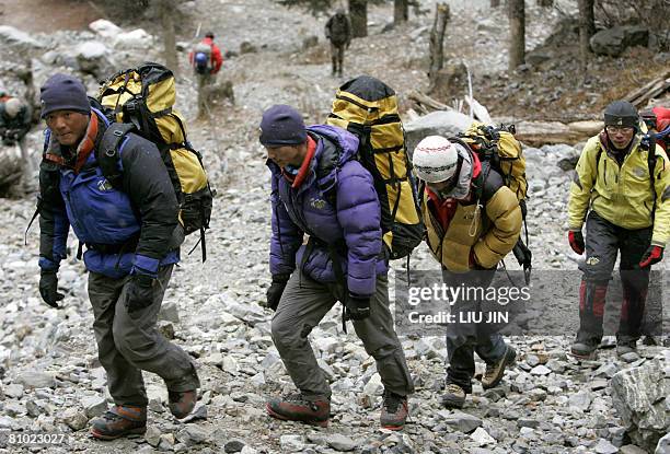 Members of a class for mountain guides march to their training base at Siguniang mountain in China's southwestern province of Sichuan on February 26,...