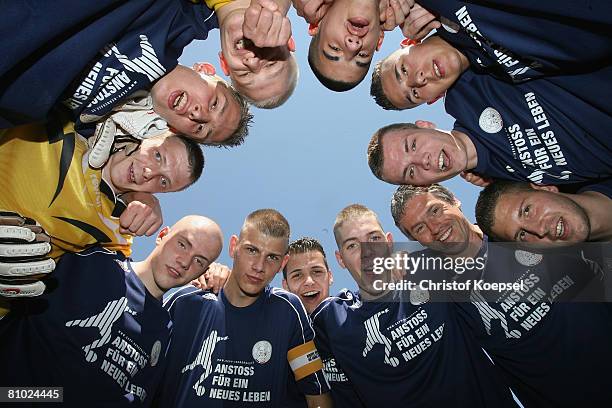 The prisoner team of Siegburg comes together to build a circle during the youth inmate football program of the German Football Association at the...