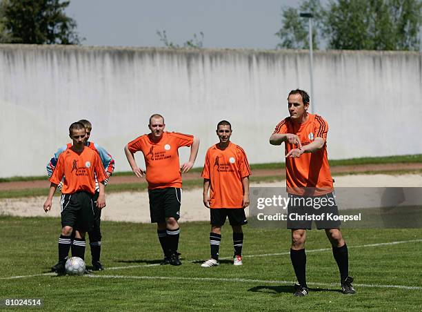 National coach Heiko Herrlich talks to prisoners during a training session during the youth inmate football program of the German Football...