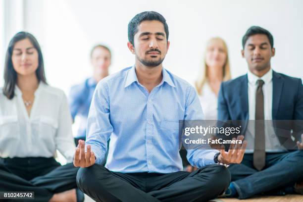 meditating at work - office yoga stock pictures, royalty-free photos & images