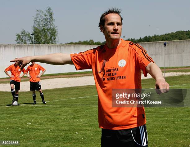 National coach Heiko Herrlich gives instructions to prisoners during a training session during the youth inmate football program of the German...