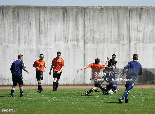 Two prisoner football teams in action during a friendly match during during the youth inmate football program of the German Football Association at...