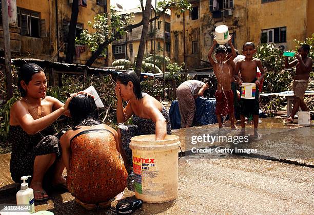 Myanmar People take a bath on the street in downtown on May 8, 2008 in Yangon, Myanmar. More then 100,000 people were killed by Cyclone Nargis,...