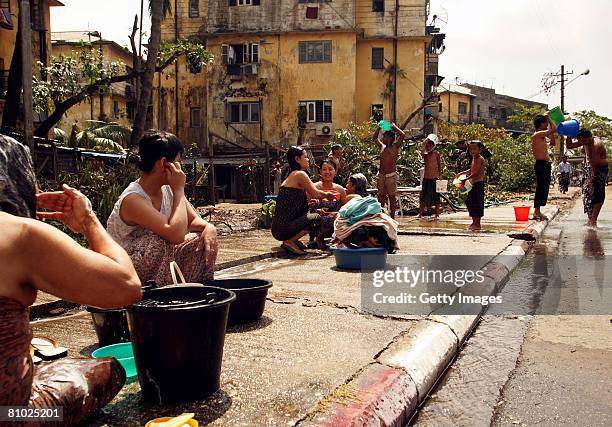 People use available water supplies to cleanse themselves on May 8, 2008 in Yangon, Myanmar. It has been estimated that more than 100,000 people were...