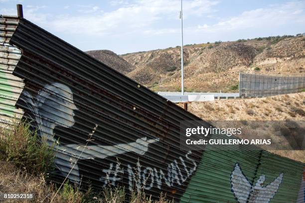 Partial view of the US-Mexico border wall painted by members of the Brotherhood Mural organization in Tijuana, Mexico on July 6, 2017. - US President...