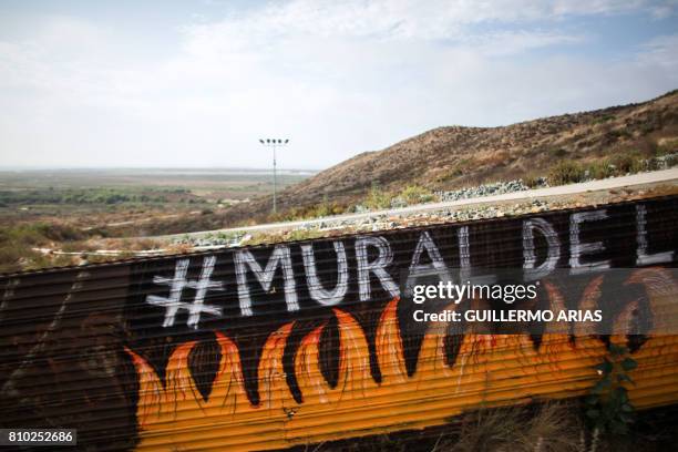 Partial view of the US-Mexico border wall painted by members of the Brotherhood Mural organization in Tijuana, Mexico on July 6, 2017. - US President...