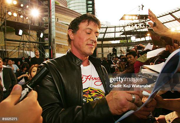 Actor Sylvester Stallone signs autographs as he walks the red carpet during "Rambo" Japan Premiere at Roppongi Hills May 8, 2008 in Tokyo, Japan. The...
