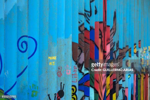 Partial view of the US-Mexico border wall painted by members of the Brotherhood Mural organization in Tijuana, Mexico on July 6, 2017. - US President...