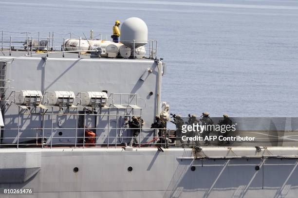 Members of French commando group Hubert take part in a drill aboard the frigate Jean de Vienne at sea off Toulon, southern France, on July 7, 2017. /...