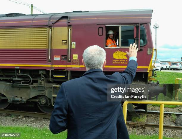 Labour Party leader Jeremy Corbyn waits to cross a railway line during a visit to the British Steel manufacturing site to tour the facility and meet...