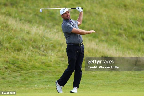 Graeme McDowell of Northern Ireland hits his second shot on the 8th hole during day two of the Dubai Duty Free Irish Open at Portstewart Golf Club on...