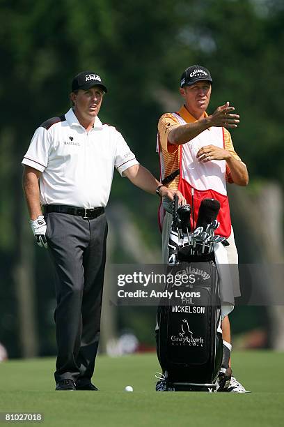 Phil Mickelson and caddie Jim "Bones" MacKay look down the fairway on the 16th hole during the first round of THE PLAYERS Championship on THE PLAYERS...